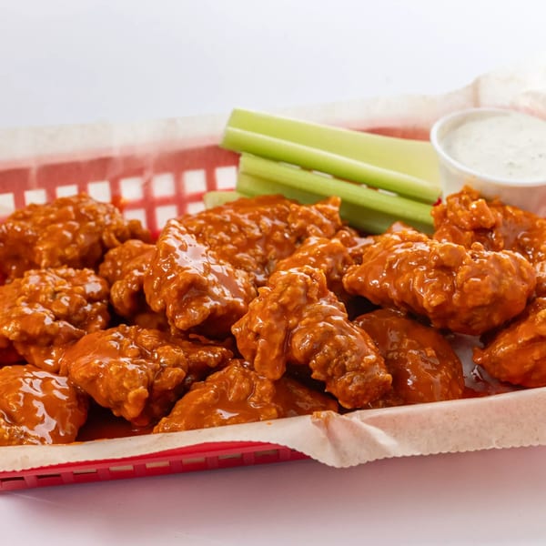 Hot Birds' fried chicken wings coated in buffalo sauce, with celery sticks and ranch dressing.